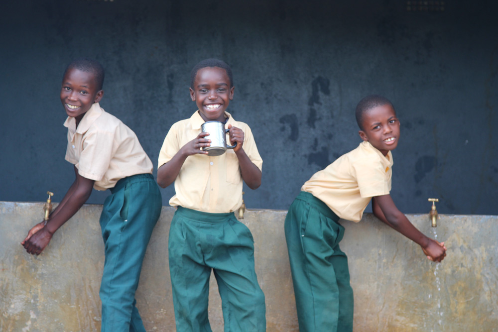 Children enjoy clean water at their ChildFund-supported school. 